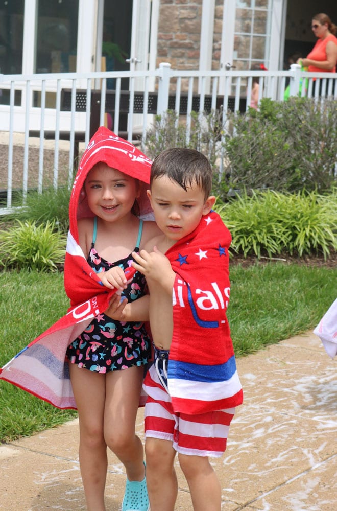 2 students wrapped in a beach towel